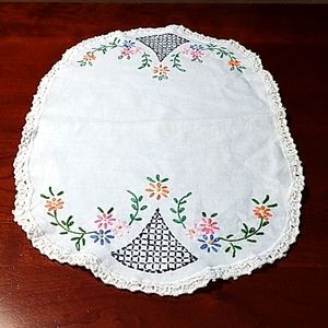 Vintage hand stitched linen table scarf with delicately colored flowers.